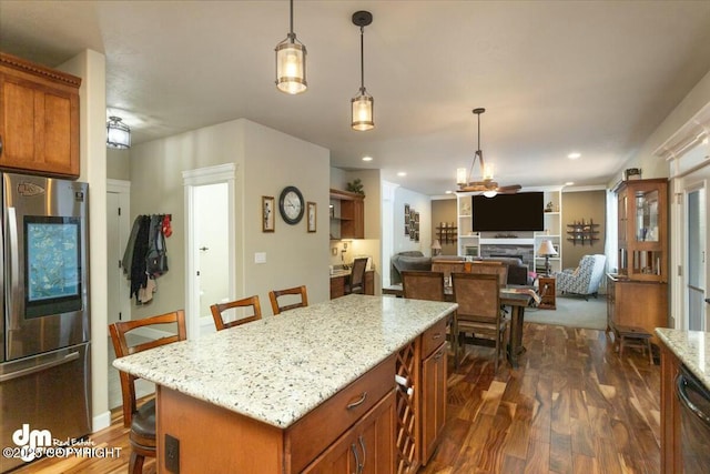 kitchen with a breakfast bar, hanging light fixtures, smart refrigerator, and dark wood-style flooring