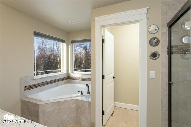 full bath with a bath and a tile shower