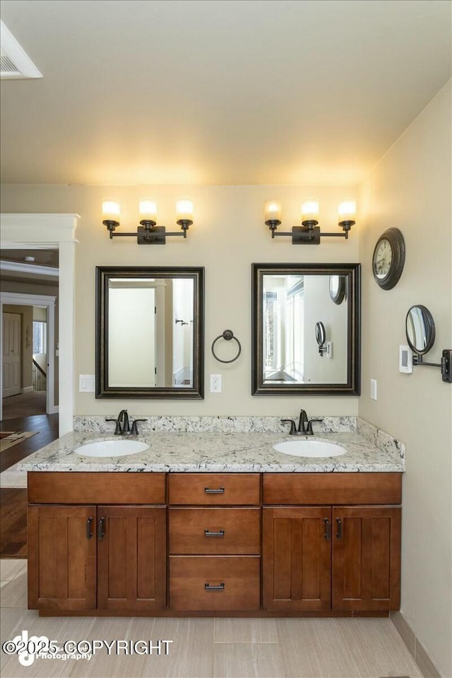 bathroom featuring a sink and double vanity