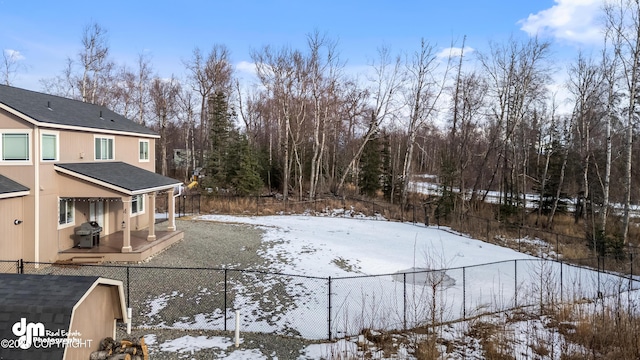 snowy yard with a fenced backyard