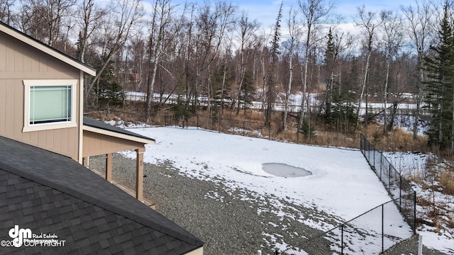 snowy yard with fence