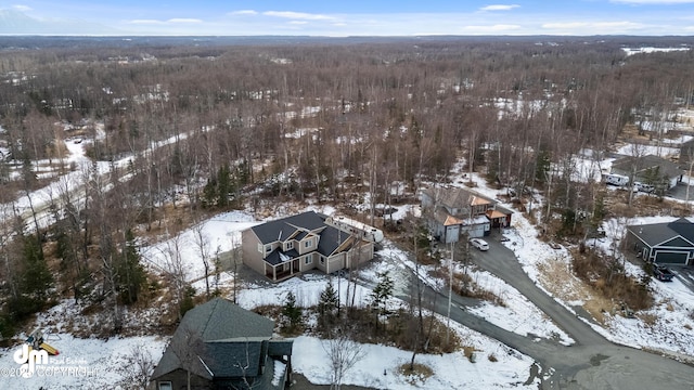 snowy aerial view featuring a view of trees