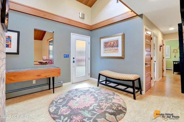 foyer entrance with a baseboard radiator and baseboards