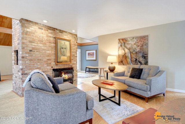 living area with recessed lighting, a brick fireplace, and baseboards