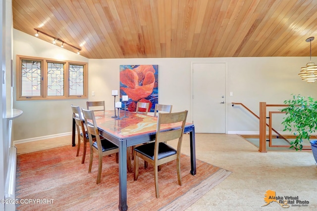 dining area featuring baseboards, lofted ceiling, wood ceiling, and track lighting