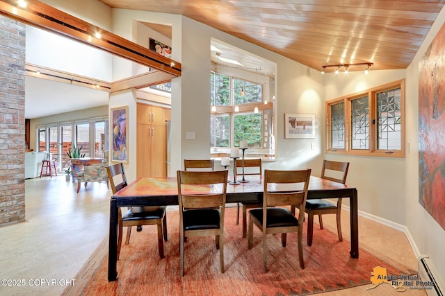 dining room with wooden ceiling, baseboards, baseboard heating, and high vaulted ceiling