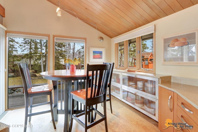 dining area featuring wooden ceiling and lofted ceiling