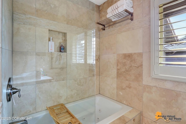 bathroom featuring a tub with jets and walk in shower