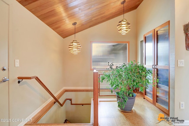 stairway featuring lofted ceiling, a notable chandelier, wood ceiling, and french doors