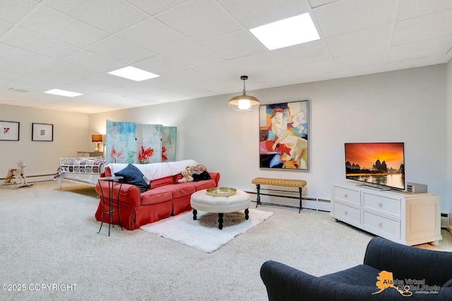 living room with carpet flooring, a paneled ceiling, and a baseboard radiator