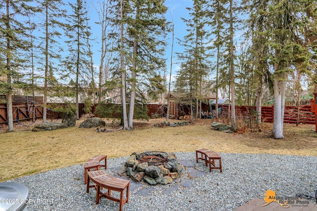 view of yard featuring a fire pit and a fenced backyard