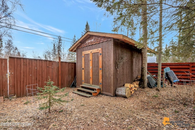 view of shed featuring a fenced backyard