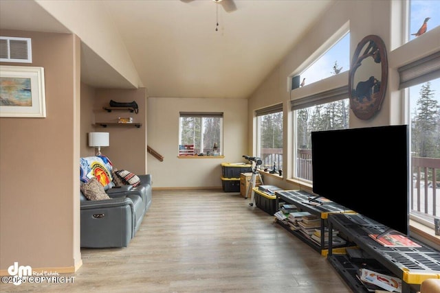 recreation room featuring visible vents, lofted ceiling, a healthy amount of sunlight, and wood finished floors