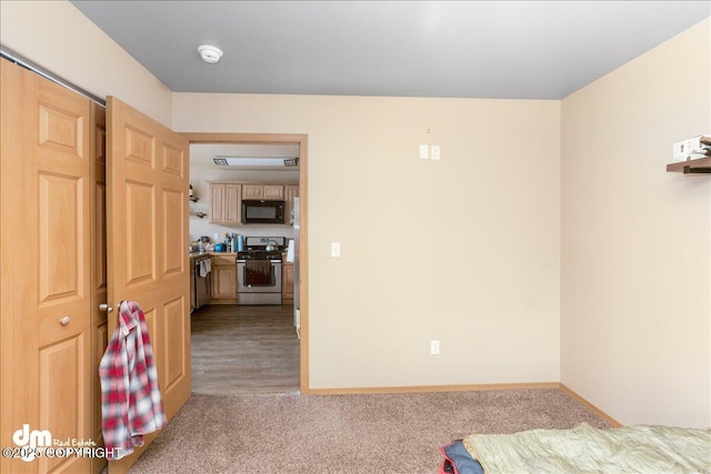 unfurnished bedroom featuring baseboards and carpet flooring