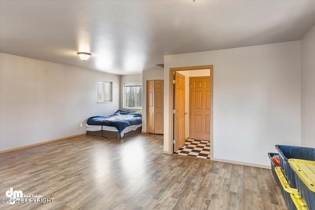 unfurnished bedroom featuring baseboards and wood finished floors