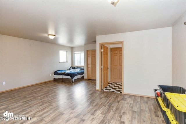 unfurnished bedroom with light wood-type flooring and baseboards