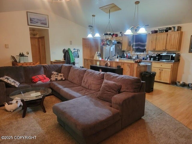 living area featuring light wood-style flooring and high vaulted ceiling