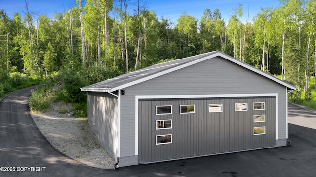 detached garage with a forest view