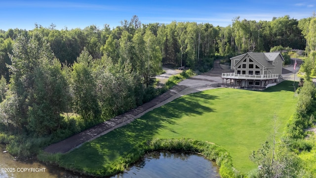 drone / aerial view featuring a view of trees