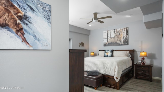 bedroom with baseboards, light wood-style floors, and ceiling fan