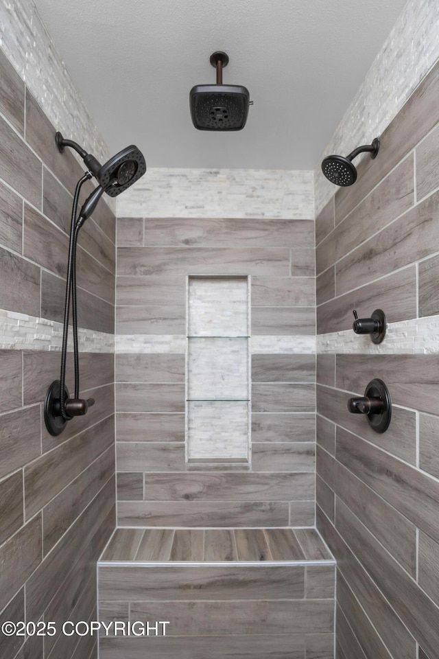 bathroom with a tile shower