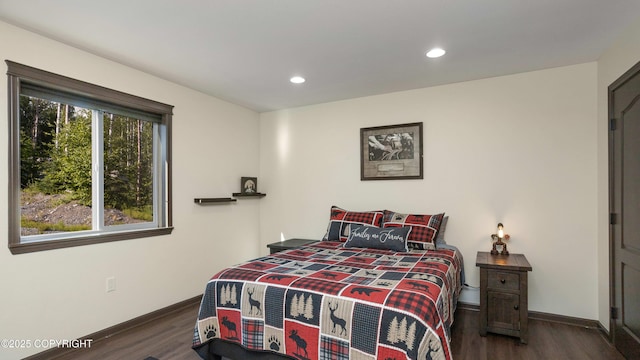 bedroom with dark wood finished floors, recessed lighting, and baseboards