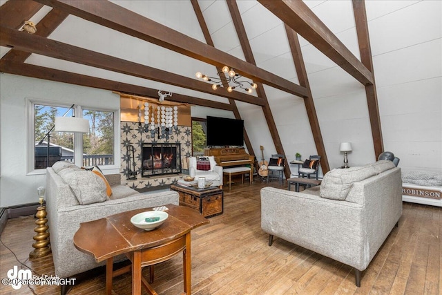 living area featuring a high end fireplace, beam ceiling, an inviting chandelier, light wood-style floors, and high vaulted ceiling