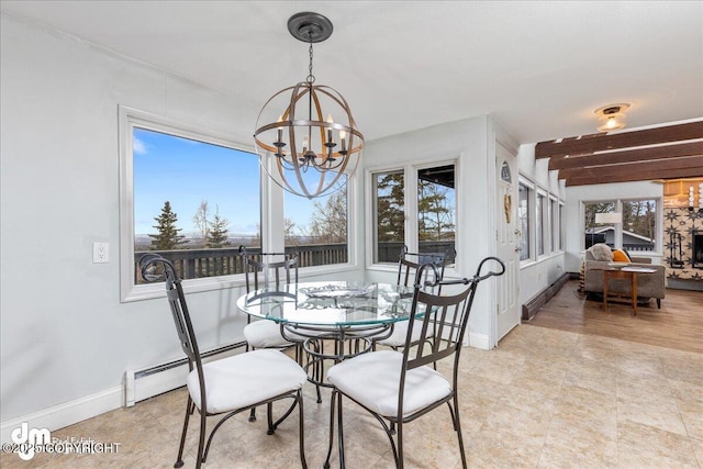 dining room featuring a baseboard radiator, baseboards, an inviting chandelier, and a fireplace with raised hearth