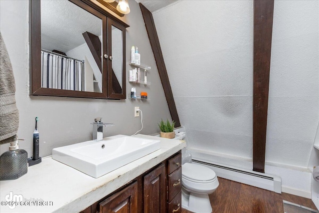 bathroom featuring a shower with curtain, toilet, wood finished floors, a baseboard radiator, and vanity