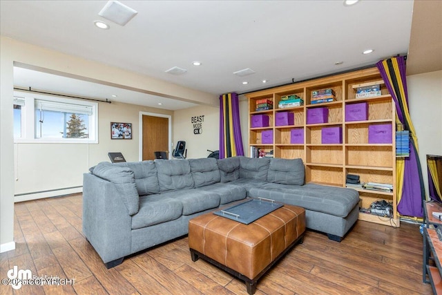 living room with recessed lighting, wood-type flooring, and a baseboard radiator