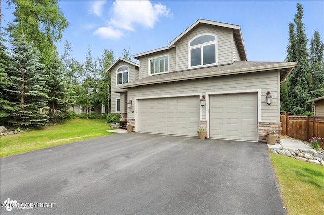 17718 Shasta Cir, Eagle River, AK 99577 - view of front of house with stone siding, asphalt driveway, and a garage