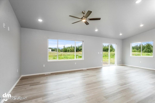 empty room with recessed lighting, baseboards, light wood-type flooring, and lofted ceiling