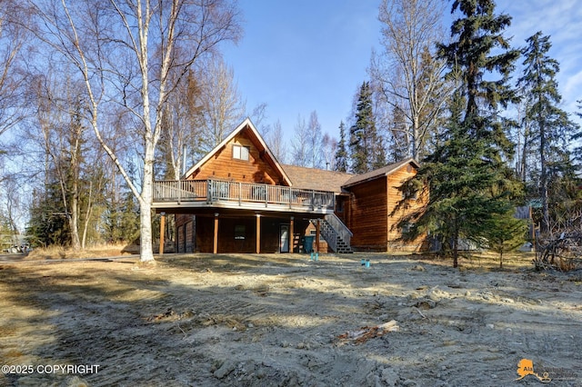 view of front of house featuring stairway and a wooden deck