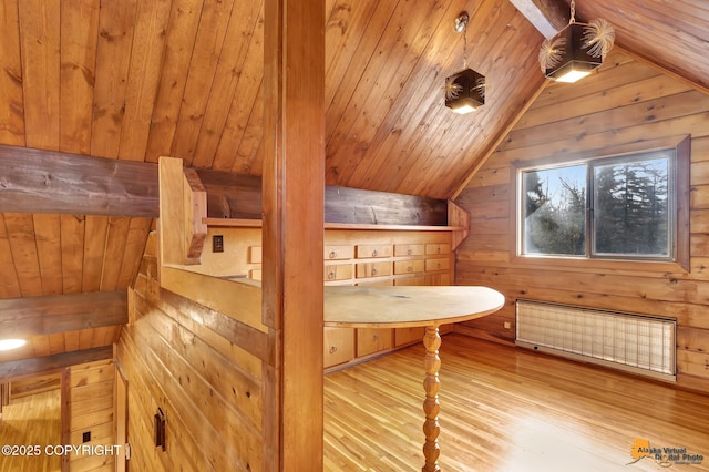 additional living space featuring wood walls, radiator heating unit, vaulted ceiling, wooden ceiling, and wood finished floors