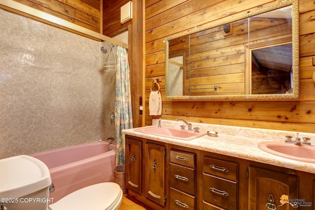 full bathroom with toilet, shower / bath combo, wood walls, and a sink