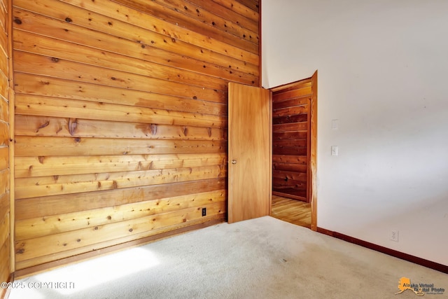 empty room featuring baseboards and carpet flooring