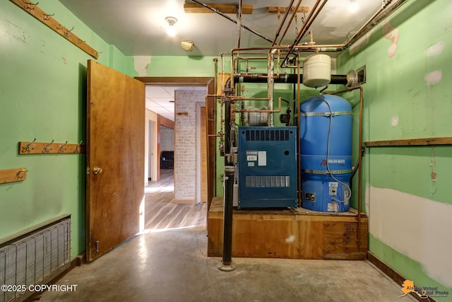 utility room with radiator and a heating unit