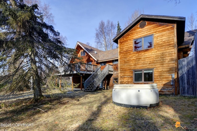 back of property with stairs and a deck