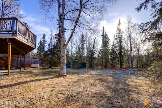 view of yard with stairway and a wooden deck