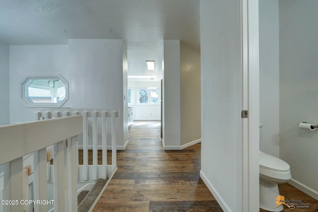 hall with wood finished floors and baseboards