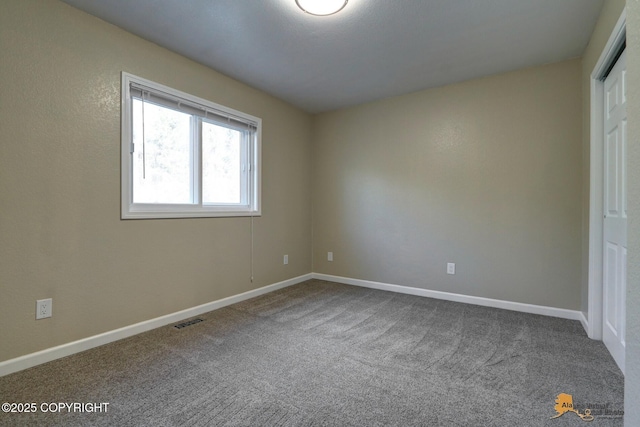 unfurnished bedroom with carpet floors and baseboards