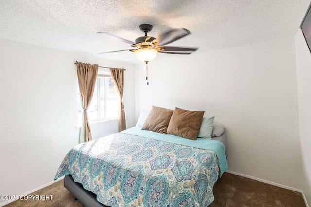 carpeted bedroom featuring ceiling fan, baseboards, and a textured ceiling