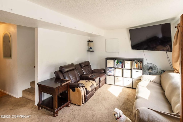 carpeted living room with a textured ceiling and stairs