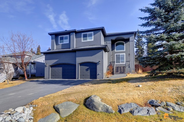 view of front of house with aphalt driveway and an attached garage