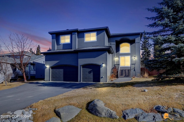 view of front of home with aphalt driveway and an attached garage