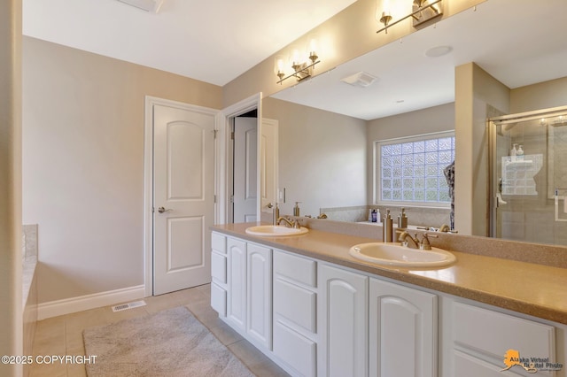 full bath featuring a sink, visible vents, a stall shower, and tile patterned floors