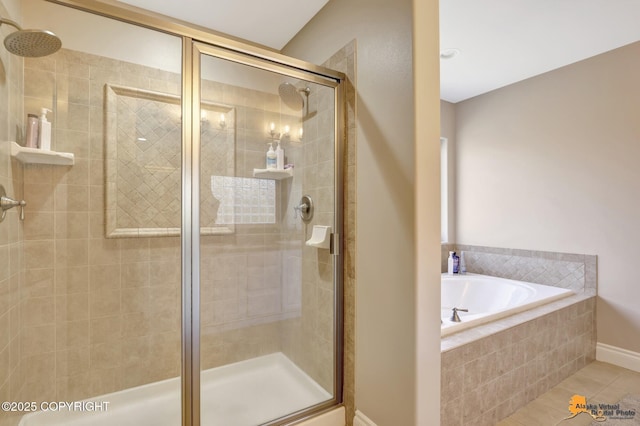 full bath with tile patterned flooring, a stall shower, and a garden tub