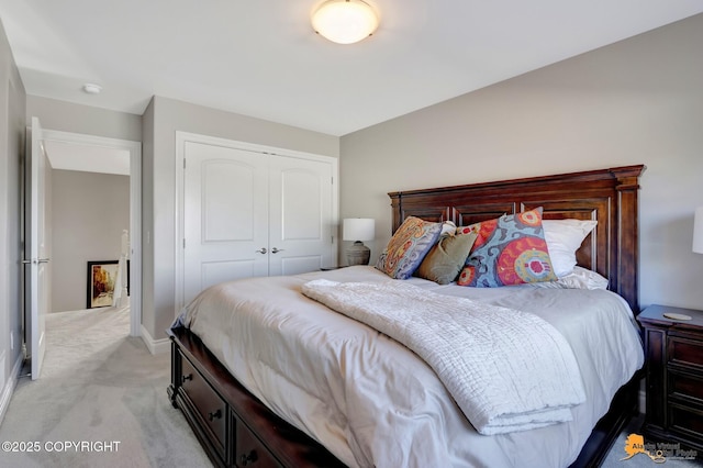 bedroom featuring baseboards, a closet, and light carpet