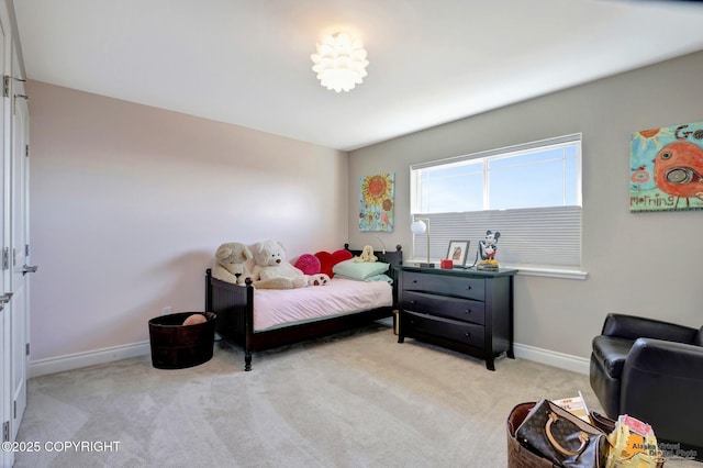 bedroom featuring baseboards and light carpet