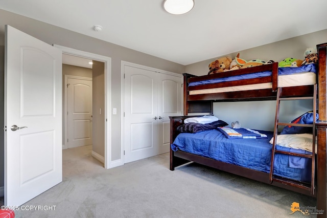 bedroom with a closet, baseboards, and carpet